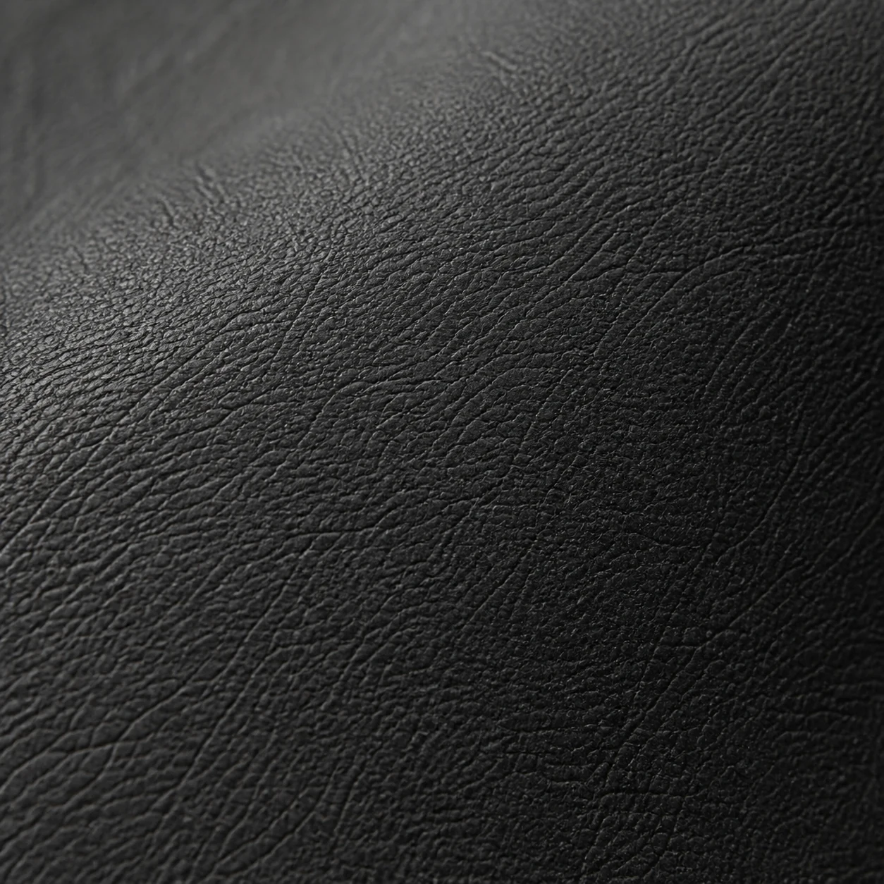 Close-up of charcoal full-grain leather upholstery