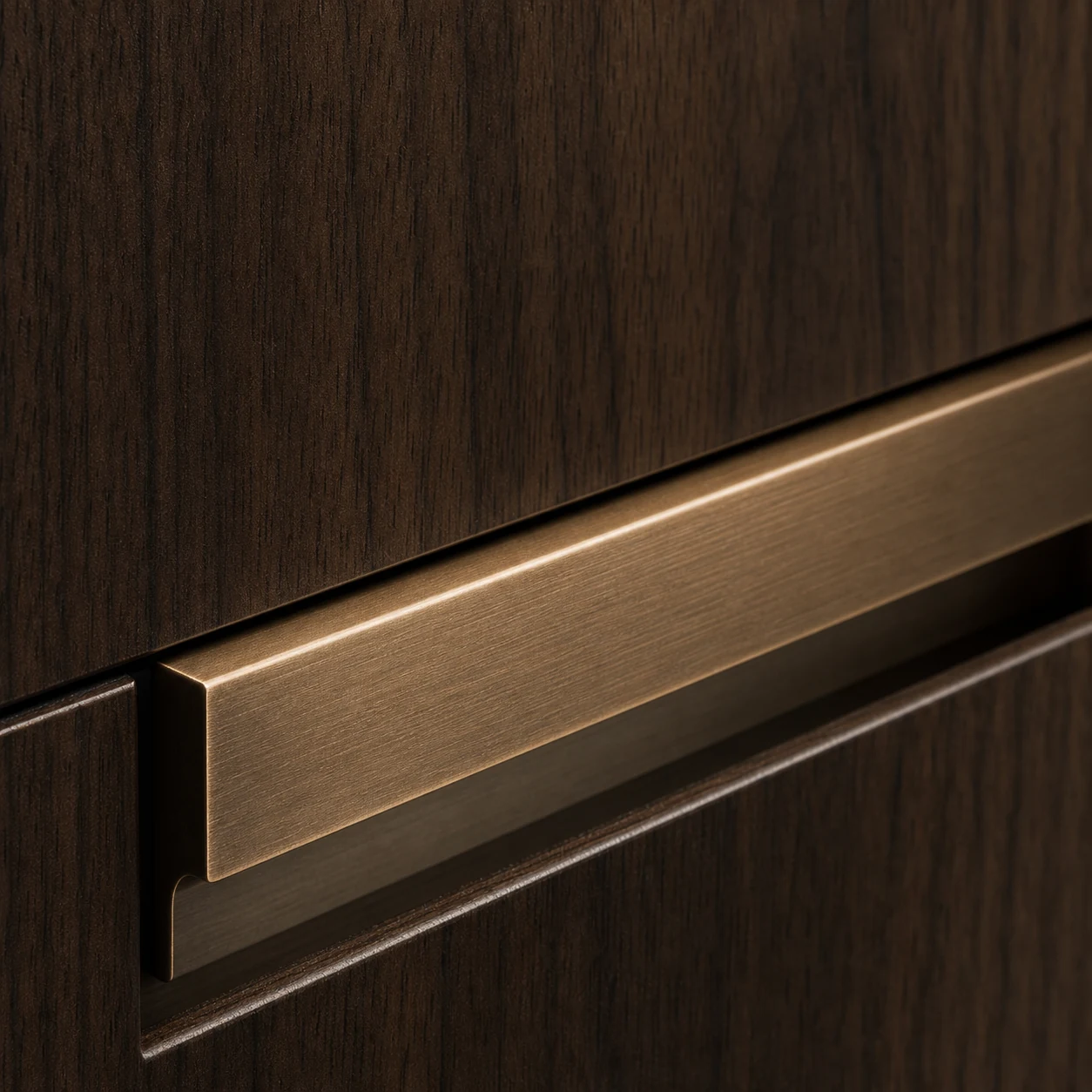 Brushed bronze recessed rail handle set into dark walnut cabinetry