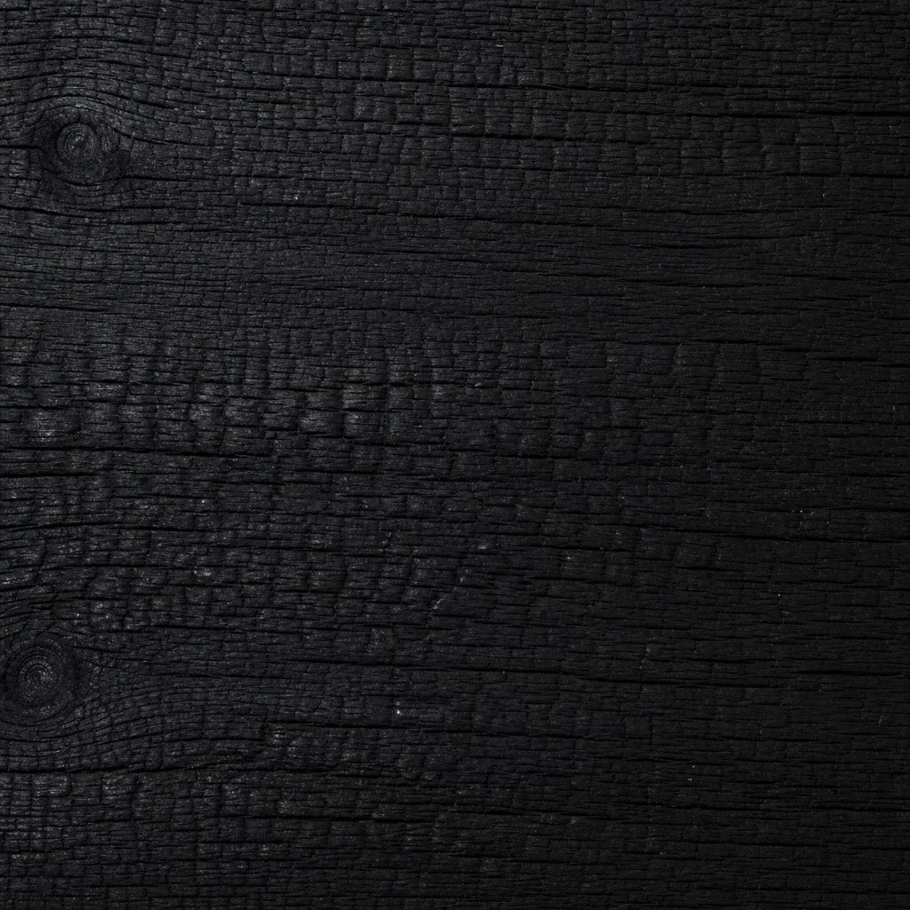 Charred timber surface with deep black textured grain