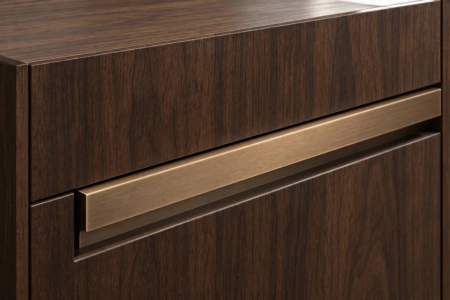Brushed bronze-coloured recessed rail handle installed between dark walnut-look kitchen drawer fronts.