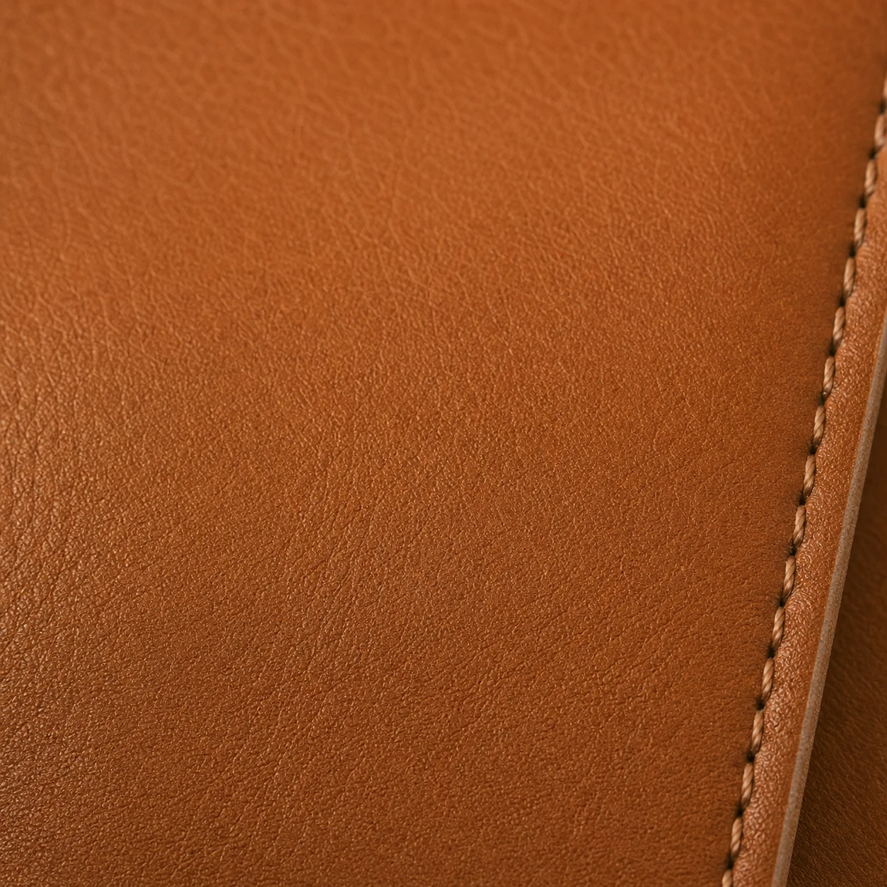Cognac leather swatch with fine stitching for interior storage