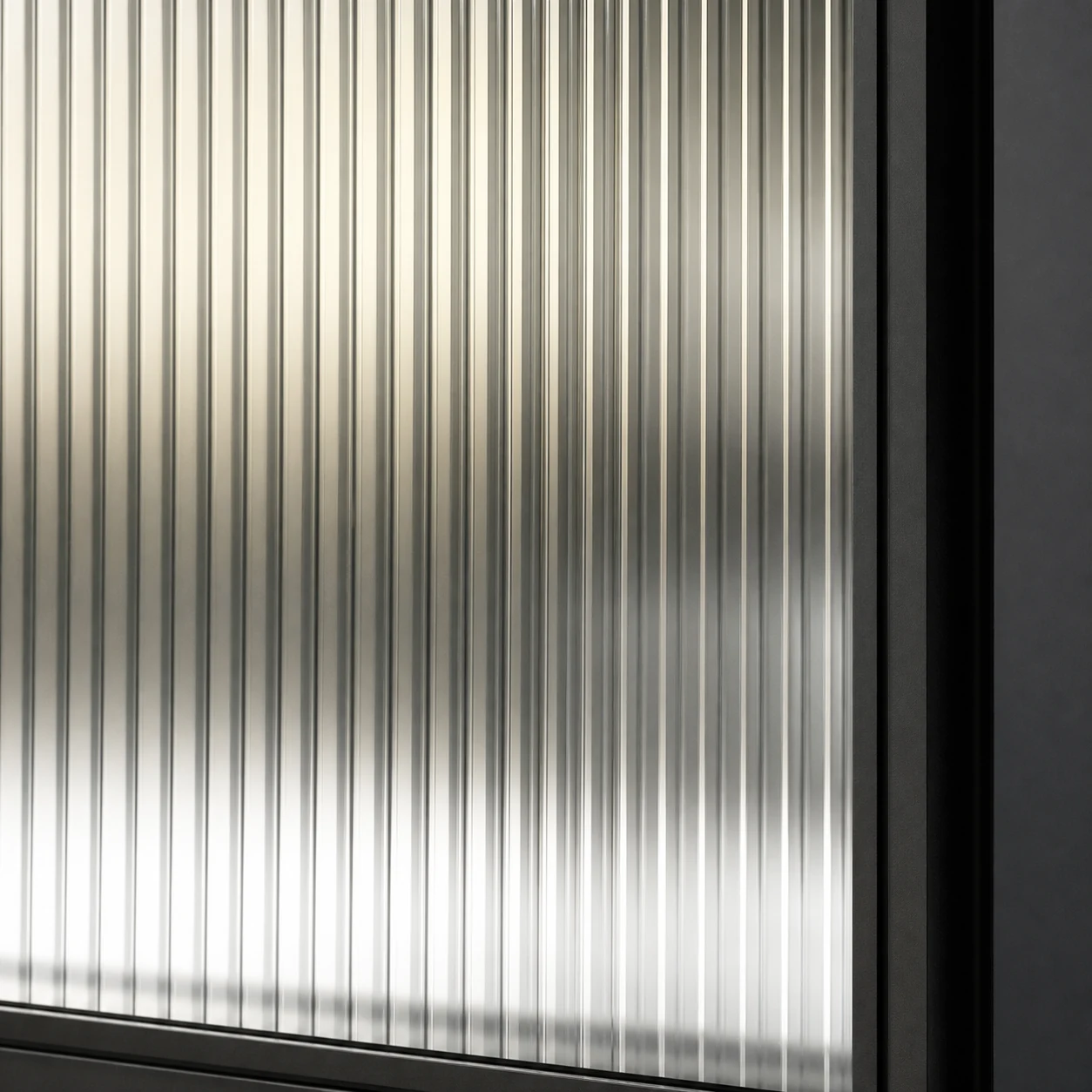 Close-up of fluted glass panel with vertical texture